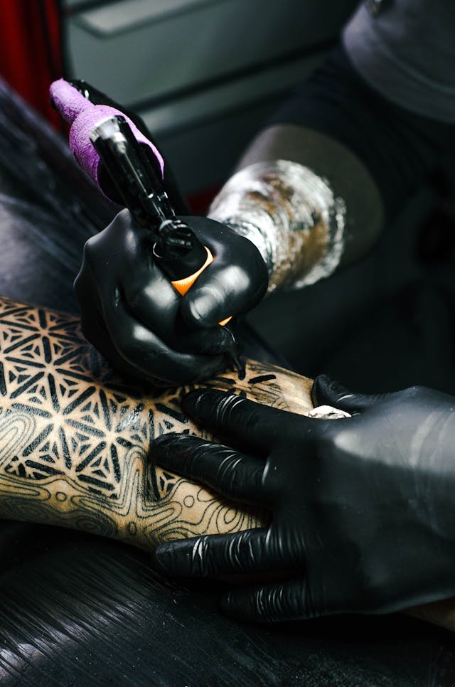 image of a tattoo artist working